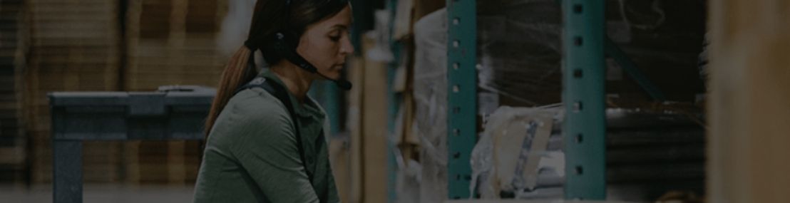 warehouse worker wearing headset using voice enabled software
